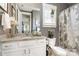 Bathroom features a white vanity with granite countertop and decorative gray shower curtain at 1575 Riverwalk Pkwy, Rock Hill, SC 29730