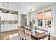 Stylish dining area featuring a large wooden table, elegant chandelier, and ample built-in cabinetry at 1575 Riverwalk Pkwy, Rock Hill, SC 29730