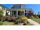 Inviting home featuring a charming front yard with colorful flowers and a covered front porch at 1575 Riverwalk Pkwy, Rock Hill, SC 29730