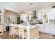 Kitchen island with sink, seating and pendant lights, open to stairs and dining at 1575 Riverwalk Pkwy, Rock Hill, SC 29730