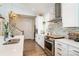 White kitchen with stainless appliances, subway tile backsplash, and hardwood floors at 1575 Riverwalk Pkwy, Rock Hill, SC 29730