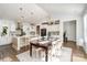 Open-concept kitchen and dining area featuring modern pendant lighting, stainless appliances, and a kitchen island at 1575 Riverwalk Pkwy, Rock Hill, SC 29730