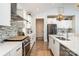 Modern kitchen with white cabinetry, stone countertops, stainless steel appliances, and stylish backsplash at 1575 Riverwalk Pkwy, Rock Hill, SC 29730