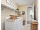 Functional laundry room with modern washer and dryer, shelving, and ample space at 1575 Riverwalk Pkwy, Rock Hill, SC 29730