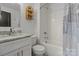 Clean bathroom featuring shower and tub combo and decorative shelf at 19705 S Ferry St, Cornelius, NC 28031