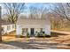 Charming single-story home featuring a covered front porch with seating and a well-maintained front yard at 19705 S Ferry St, Cornelius, NC 28031