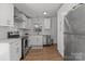 Bright kitchen features white cabinets, stainless steel appliances and a window over the sink at 19705 S Ferry St, Cornelius, NC 28031