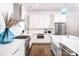 Bright kitchen featuring white cabinets, marble island, and farmhouse sink at 2002 Summey Ave # 3, Charlotte, NC 28205