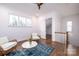 Sitting room with two wicker chairs, a rug, and a view of the upper hallway at 2002 Summey Ave # 3, Charlotte, NC 28205