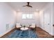 Bright sitting room with two wicker chairs and a patterned rug at 2002 Summey Ave # 3, Charlotte, NC 28205