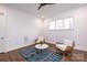 Bright sitting room with two wicker chairs and a patterned rug at 2002 Summey Ave # 3, Charlotte, NC 28205