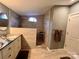 Modern bathroom with walk-in shower and granite vanity at 203 Shane Dr, Mount Holly, NC 28120