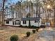 Ranch style home with mature trees, a shed, and a paved driveway at 203 Shane Dr, Mount Holly, NC 28120