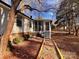 Home exterior showcasing a screened porch and landscaping at 203 Shane Dr, Mount Holly, NC 28120