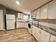 Modern kitchen featuring white cabinets, granite countertops, and stainless steel appliances at 203 Shane Dr, Mount Holly, NC 28120