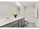 Bathroom with double vanity, tub, and gray cabinets at 2101 Morgan Hills Dr # 155P, Albemarle, NC 28001