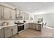 Modern kitchen with gray cabinets, stainless steel appliances, and white backsplash at 2101 Morgan Hills Dr # 155P, Albemarle, NC 28001