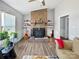 Living room with brick fireplace and wood-look floors at 2316 Woodfield Cir, Gastonia, NC 28056