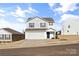 Two-story house with white siding, a two-car garage, and a blue front door at 2513 Celestial Dr, Newton, NC 28568