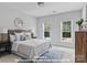 This light-filled bedroom has two large windows, neutral walls, and an area rug for a cozy design at 270 Gilead Rd, Huntersville, NC 28078