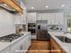 This kitchen features white cabinets, stainless steel appliances, and wood floor at 270 Gilead Rd, Huntersville, NC 28078