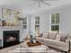 Cozy living room featuring a fireplace and large windows at 270 Gilead Rd, Huntersville, NC 28078