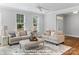 Bright living room with neutral tones, two sofas, an ottoman, large windows and wood floors at 270 Gilead Rd, Huntersville, NC 28078