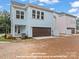 Townhouse rear elevation showcasing garages and brick pavers at 270 Gilead Rd, Huntersville, NC 28078