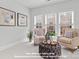 Bright sitting area in the main bedroom with two chairs, ottoman, and large windows at 270 Gilead Rd, Huntersville, NC 28078