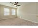 Simple bedroom with neutral walls and carpet, and ceiling fan at 315 Valley Brook Se Ln, Concord, NC 28025