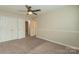 Bedroom with neutral walls, carpet, and double door closet at 315 Valley Brook Se Ln, Concord, NC 28025