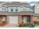 Brick front exterior of townhome with attached garage and landscaping at 315 Valley Brook Se Ln, Concord, NC 28025