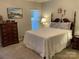 Bedroom with a large bed, blinds, and neutral color scheme at 3818 Carl Parmer Dr, Harrisburg, NC 28075