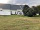 Back exterior view with landscaping and yard at 3818 Carl Parmer Dr, Harrisburg, NC 28075