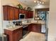 Well-lit kitchen featuring granite countertops, stainless steel appliances, and wood cabinets at 3818 Carl Parmer Dr, Harrisburg, NC 28075