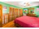 Bedroom with wood furniture, green walls, and hardwood floors at 3870 Elkwood Ct, Concord, NC 28025