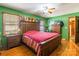 Bedroom with wood furniture, green walls, and hardwood floors at 3870 Elkwood Ct, Concord, NC 28025