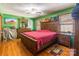 Bedroom with wood furniture, green walls, and hardwood floors at 3870 Elkwood Ct, Concord, NC 28025