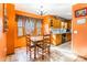 Eat-in kitchen with orange walls and wood cabinets at 3870 Elkwood Ct, Concord, NC 28025