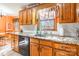 Kitchen with granite countertops, wood cabinets, and a window view at 3870 Elkwood Ct, Concord, NC 28025