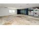 Unfinished basement space with concrete flooring, built-in shelving, and storage cabinets, awaiting customization at 4029 Wild Nursery Ct, Charlotte, NC 28215