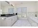 Bright bathroom featuring a double vanity, large windows and a soaking tub at 4029 Wild Nursery Ct, Charlotte, NC 28215