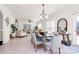 Open concept dining area with modern chairs and a large table, adjacent to living room at 4029 Wild Nursery Ct, Charlotte, NC 28215