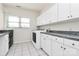 Bright laundry room with white cabinets, ample counter space, and a convenient washer and dryer setup at 4029 Wild Nursery Ct, Charlotte, NC 28215