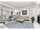 Elegant living room with tray ceilings, stylish furniture, and large windows for natural light at 4029 Wild Nursery Ct, Charlotte, NC 28215