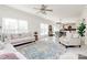 Bright living room with large windows, neutral furniture, and an open layout to the dining area at 4029 Wild Nursery Ct, Charlotte, NC 28215