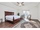 Primary bedroom with ceiling fan, tray ceiling, hardwood floors and area rug at 4029 Wild Nursery Ct, Charlotte, NC 28215