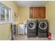 Convenient laundry room with washer, dryer, and storage cabinets at 4070 Timber Crossing Dr, Rock Hill, SC 29730