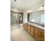 Bathroom with double vanity, granite countertop, and shower at 412 Catawba Ave, Davidson, NC 28036