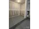 Unfinished storage area in the garage with gray epoxy flooring at 412 Catawba Ave, Davidson, NC 28036